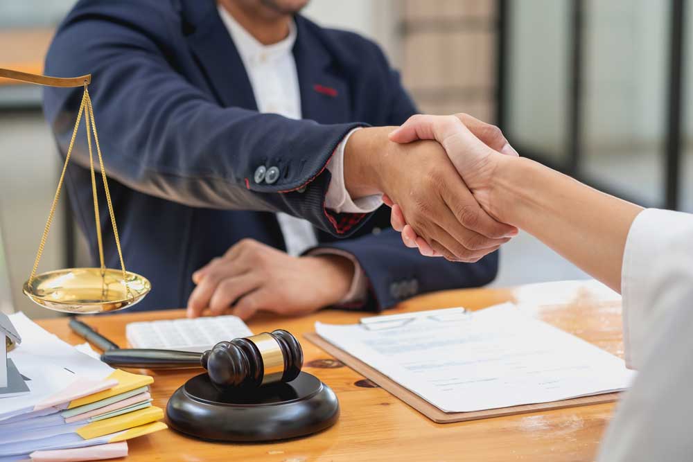 Solicitor shaking hands with client