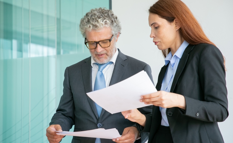 Two people reviewing paperwork. 
