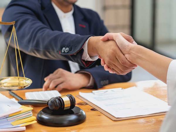Solicitor shaking hands with client