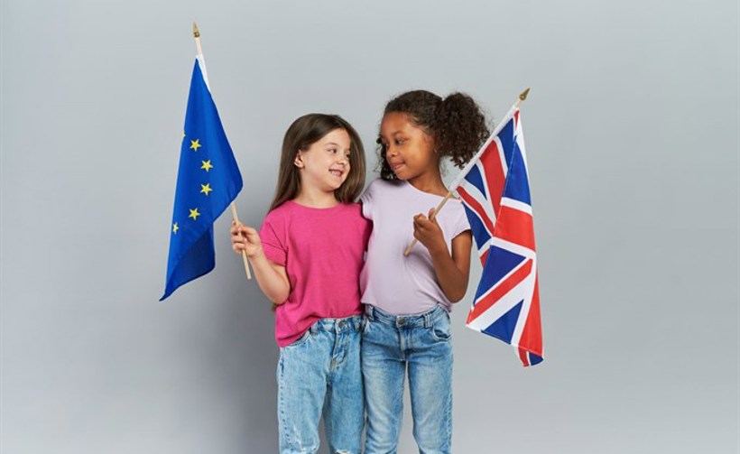 Girls Embracing Holding British European Union Flags